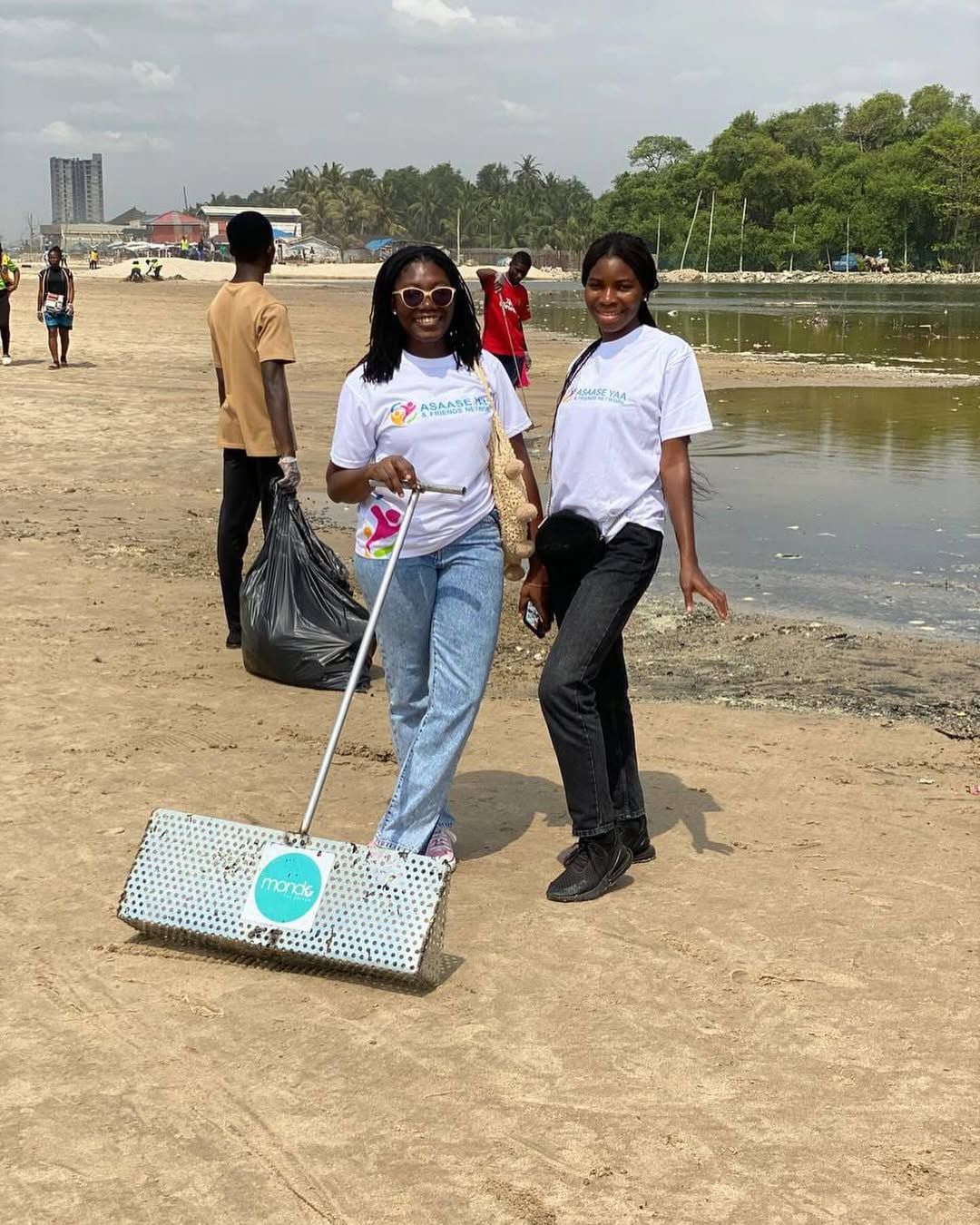 Volunteers raking rubbish from the sand